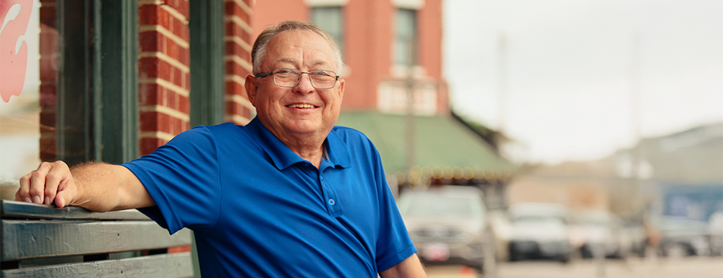 Image of actual hearing aid wearer Stan outside a building