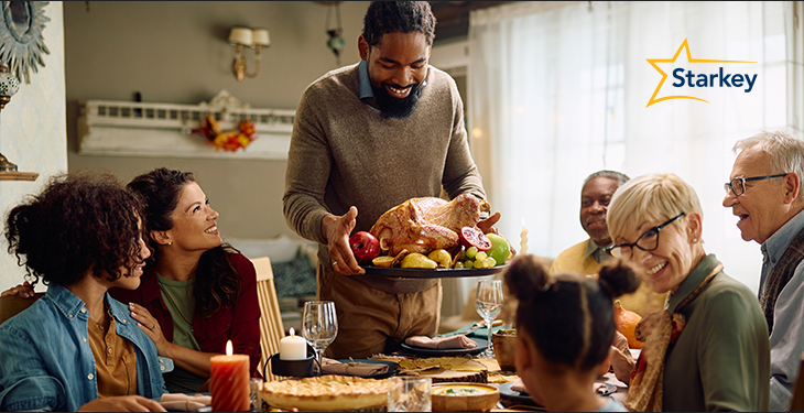 Image of family having dinner around a table 