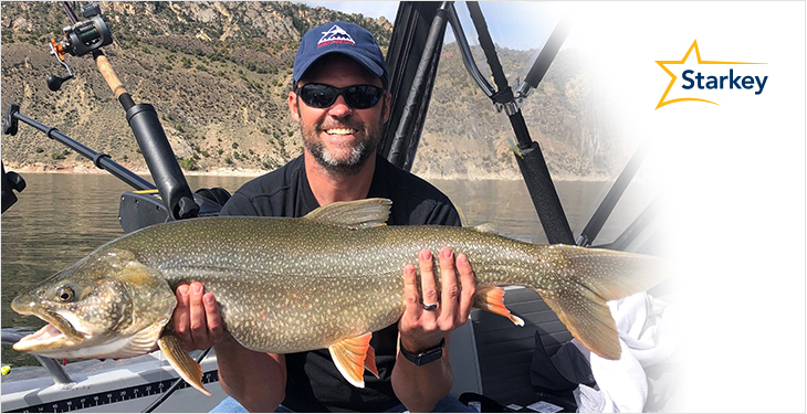 Image of Justin Osmond holding large fish he caught while fishing