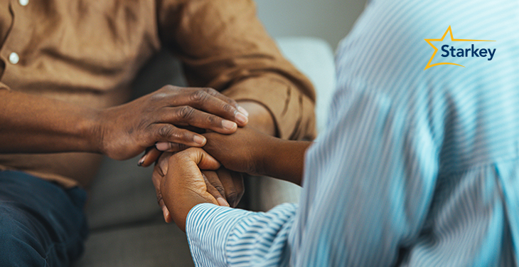Image of someone holding another's hands and counseling them