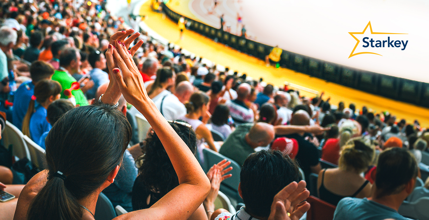 Image of crowd cheering while watching a track and field event