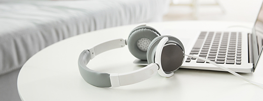 Image of headphones and laptop sitting on a table